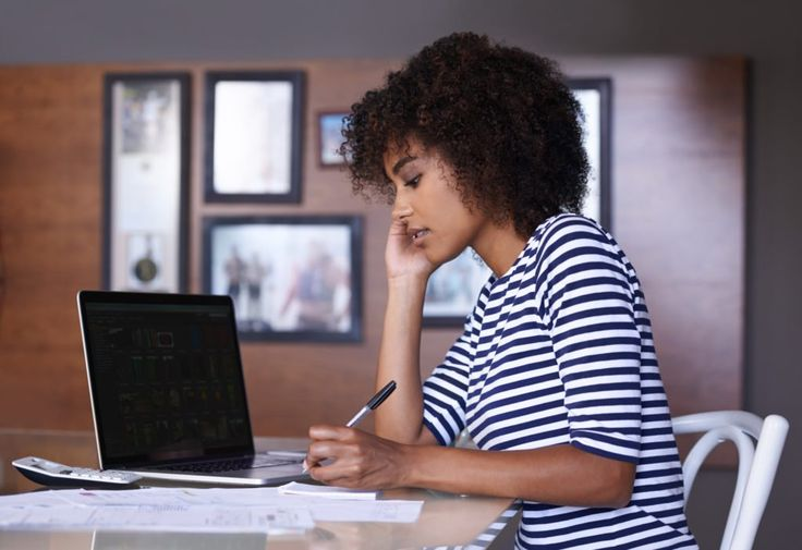 woman sittng in front of a laptop- Data Analyst